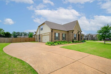 View of side of home featuring brick siding, driveway, a garage, and a shingled roof