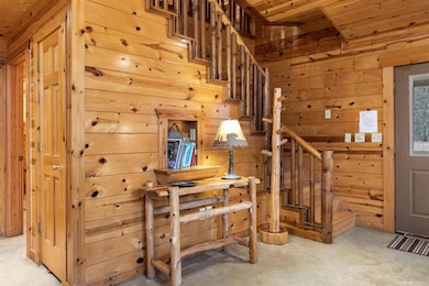 Staircase featuring wood walls