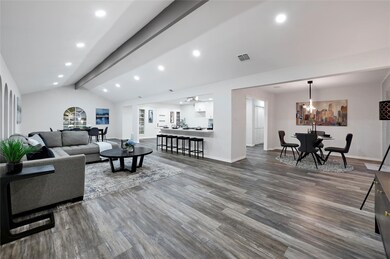 This spacious living area features modern wood flo