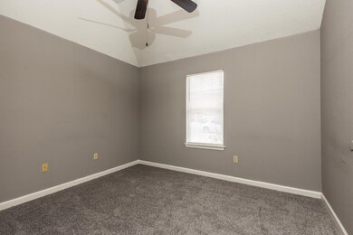 Unfurnished room with lofted ceiling, a ceiling fa