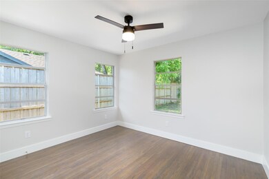 Empty room with dark hardwood / wood-style floorin