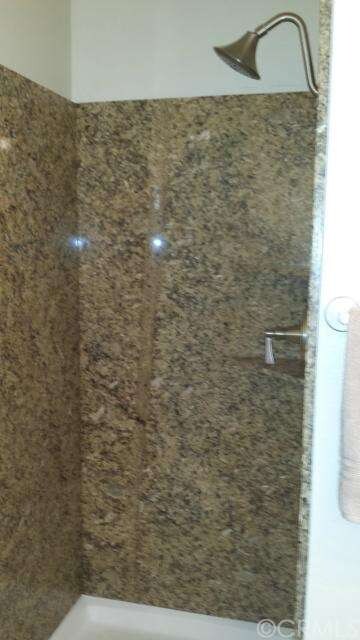 Full granite bathroom shower in downstairs bathroo