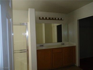 Full bath featuring double vanity, a sink, and a s