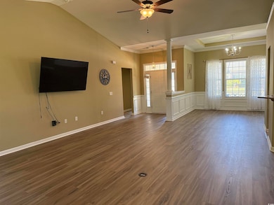 Unfurnished living room featuring dark wood-style 
