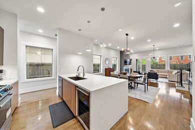 Quartz waterfall counter, contemporary cabinetry a