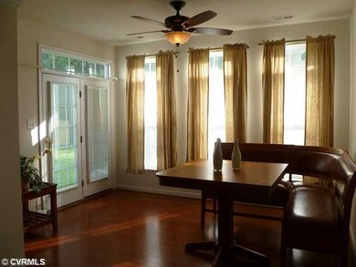 Other - The sunroom flows nicely from the other living spaces. The rear wall of windows add an elegant touch. The French doors lead to the rear patio.