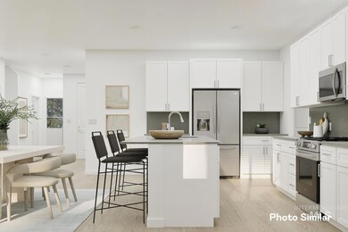 Kitchen with backsplash, stainless steel appliances, light wood-type flooring, and a breakfast bar area