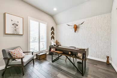 The home office boasts an accent wall and high cei