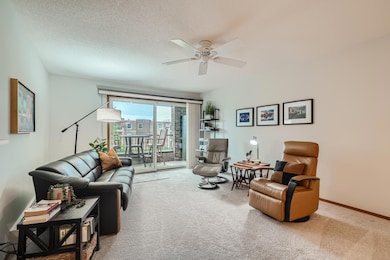 Living room with lots of natural light leading to private balcony