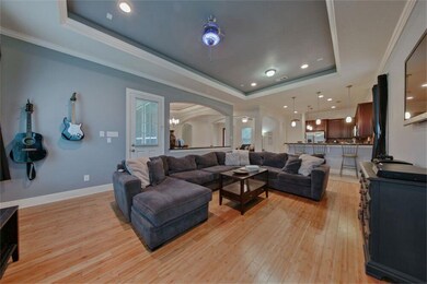 Family room has coffered ceiling with inset lighting, pre wired for surround sound and bamboo flooring