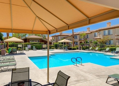 Community pool with a gazebo, a patio area, and a