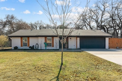Single story home featuring a garage and a front l