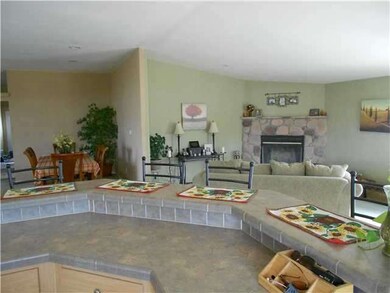 KITCHEN BAR LOOKING TO THE FAMILY ROOM AND DINING 
