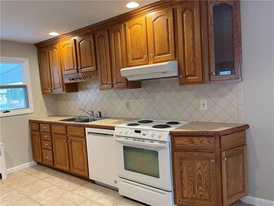 Spacious kitchen featuring solid wood cabinetry, a