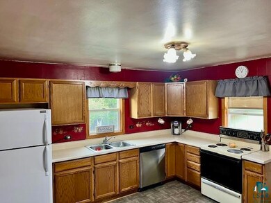 Kitchen with sink, dark parquet floors, and white 