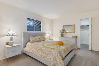 Bedroom with carpet floors and a walk in closet
