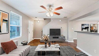 Living room featuring wood finished floors, a cei