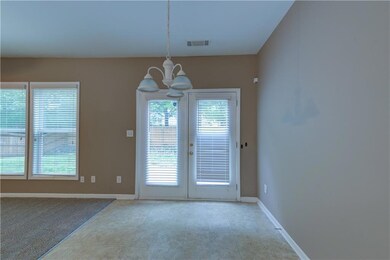 Unfurnished dining area featuring a chandelier, healthy amount of natural light, and baseboards