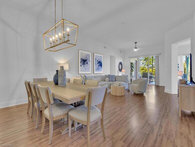 Dining room with baseboards, an inviting chandelier, and light wood-type flooring