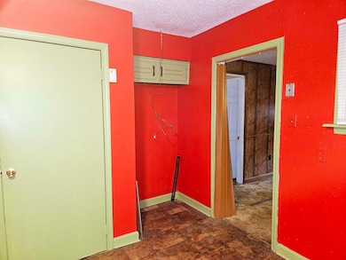 Corridor with dark tile patterned floors and a tex