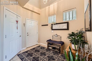 Tiled foyer featuring baseboards