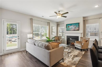 Living room featuring dark wood-style flooring, ba