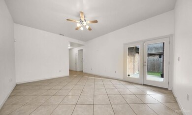 Empty room featuring french doors, ceiling fan, and light tile floors