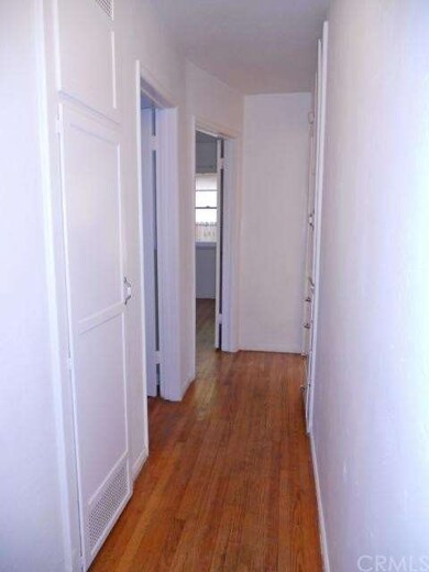 Hallway with spacious linen closet and newly refin