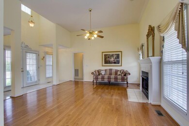 LIVING ROOM WITH HIGH CEILINGS AND GORGEOUS FINISHED WOOD FLOORS.