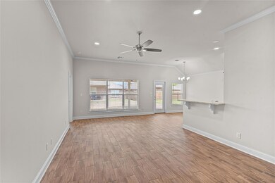 Unfurnished living room with crown molding, basebo