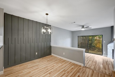 Spare room featuring wood finished floors, basebo