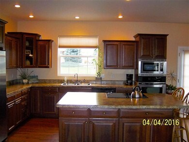 Kitchen opens to living room and dining area with easy access to backyard.