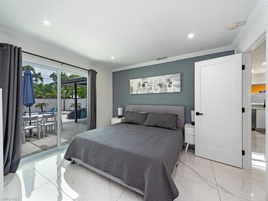 Bedroom with ornamental molding, light tile floori