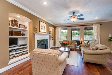 Walk into this warm, welcoming living room that looks out to the backyard and pool.