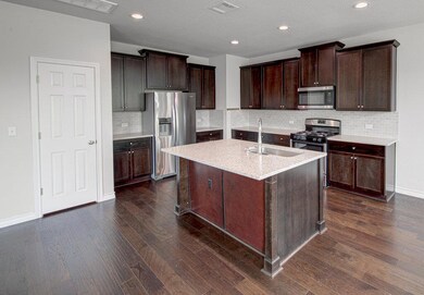 Kitchen with stainless steel appliances, a sink, 
