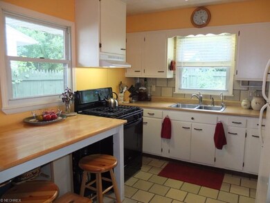 Eat-in kitchen with tile flooring.