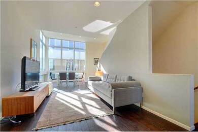 Living room with hardwood floors, volume ceilings 
