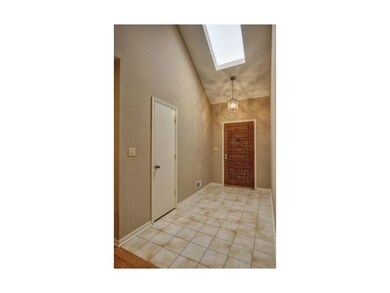 Front door, lovely marble tile and sky light.