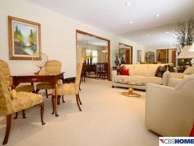What a great feel this home has! Living and dining rooms have beautiful hardwoods currently covered by Ralph Lauren carpet. View from front foyer.