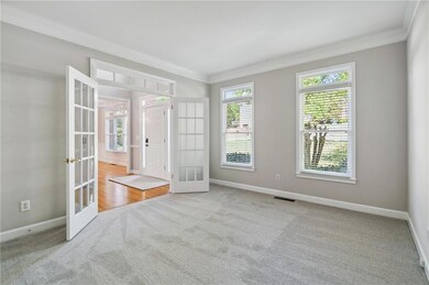 Spare room with ornamental molding, french doors, 