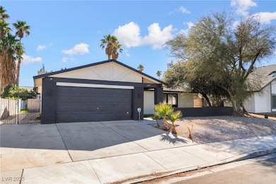 Single story home with concrete driveway, stucco siding, and a garage