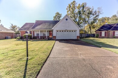 View of front of house featuring central AC, a gar