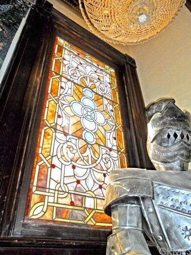 Original stained glass window at first landing of 
