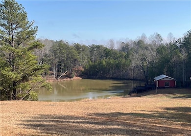 Water view with a heavily wooded area