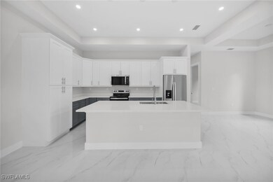 Kitchen with white cabinetry, a center island with