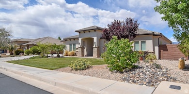 View of front of house with a tiled roof, fence, a front lawn, and stucco siding