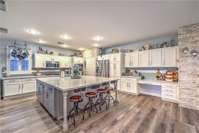 Kitchen with stainless steel appliances, white cab