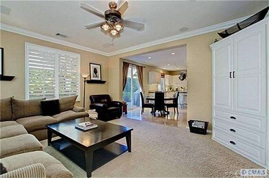 With subtle taupe wall paint, crown molding and pl