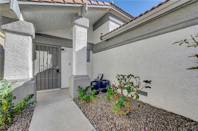 Doorway to property featuring a tiled roof and stucco siding