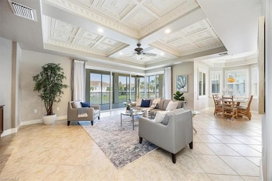 Tiled living room with crown molding, coffered cei